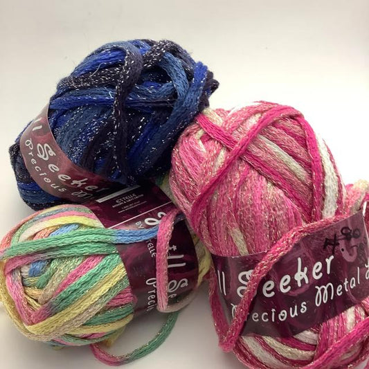 A group image of three multi colour degradé mesh scarf yarns with shimmery threads