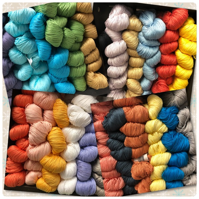 product photo of cascade noble cotton yarn in skeins on the shelf at romni wools