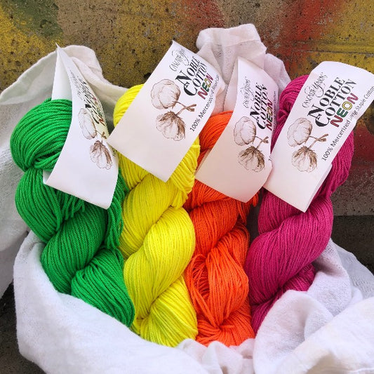 product photograph of skeins of cascade noble cotton neon colours
